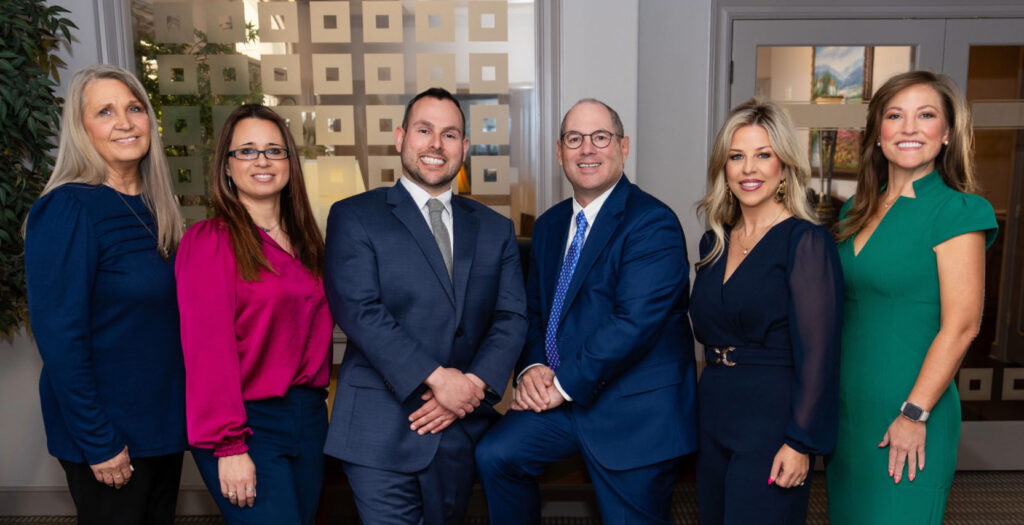 The winston wealth advisors team smiling in a conference room